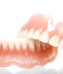 Full set of traditional dentures against white background
