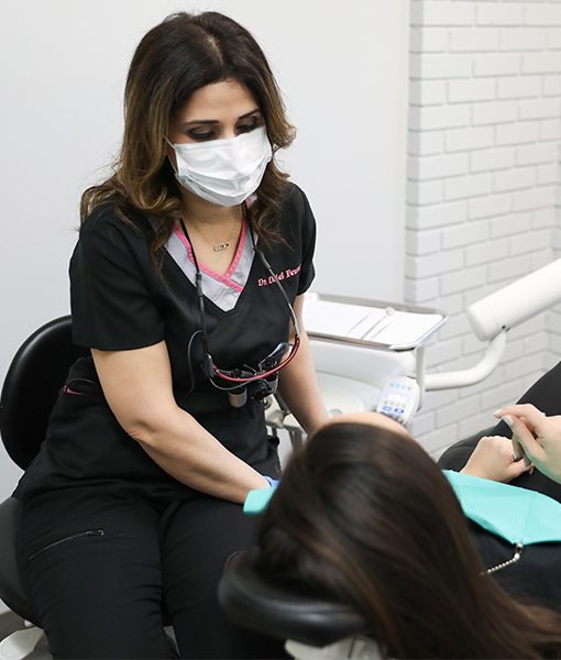 Dentist talking to dental patient during emergency dentistry treatment