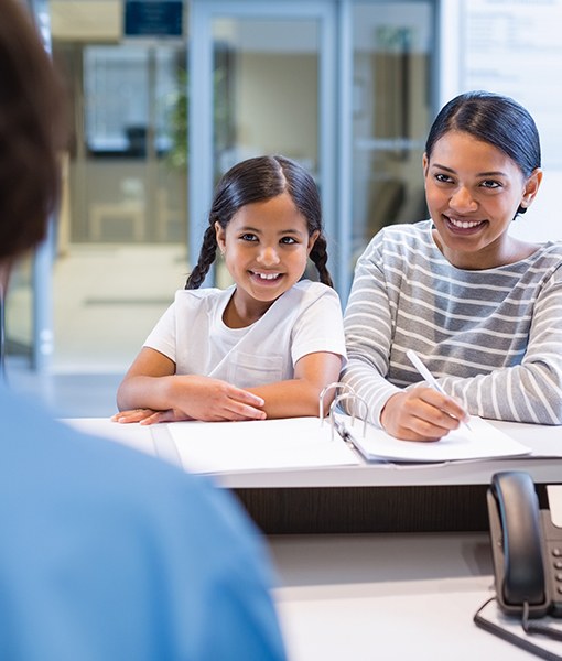 Mother and daughter checking in at front desk