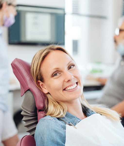 Woman smiling at dentist in Edmonton