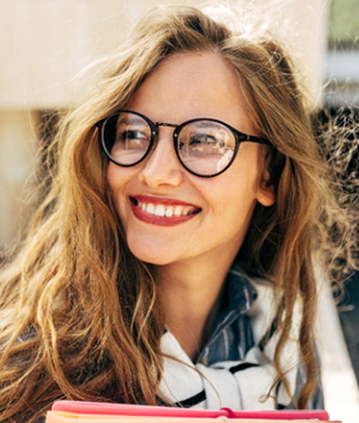 Woman outside smiling with dental bonding in Edmonton