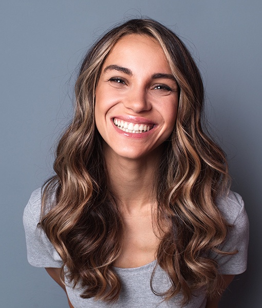 Woman sharing flawless smile after gum recontouring