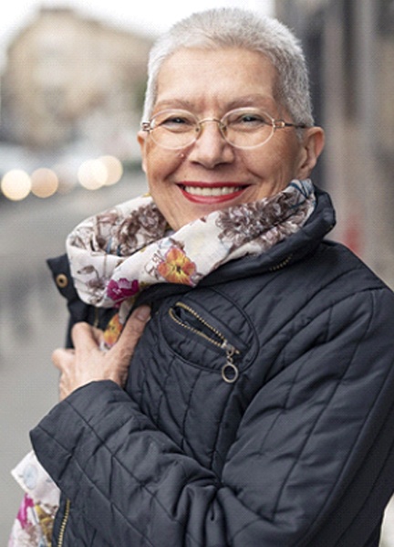 Woman smiling with dental bridge in Edmonton