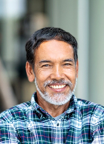 Man smiling with dental crown in Edmonton