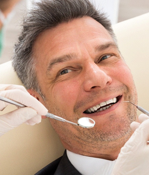 Man at dentist getting dental crown in Edmonton