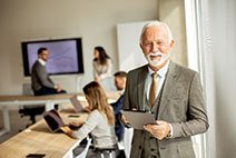 An older man in an office meeting room