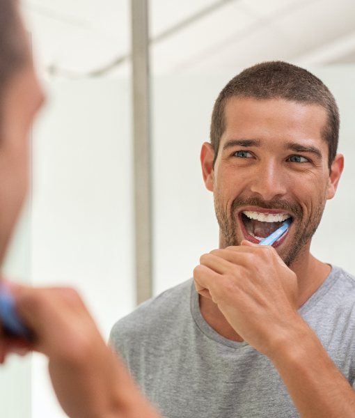 Man brushing teeth to prevent dental emergencies