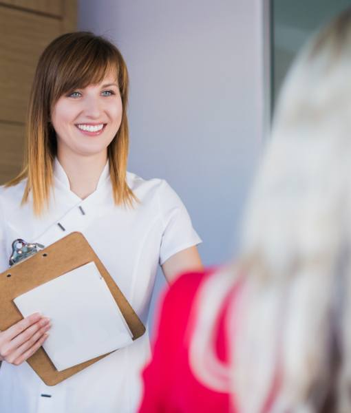 Dental team member discussing the cost of emergency dentistry with patient