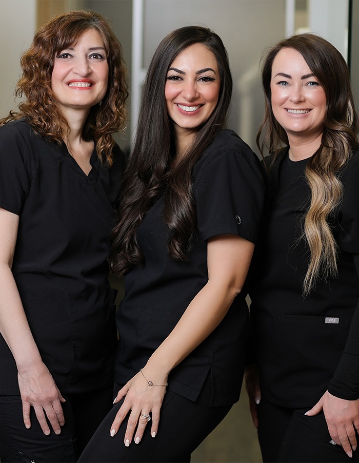 Three smiling dental team members in Edmonton