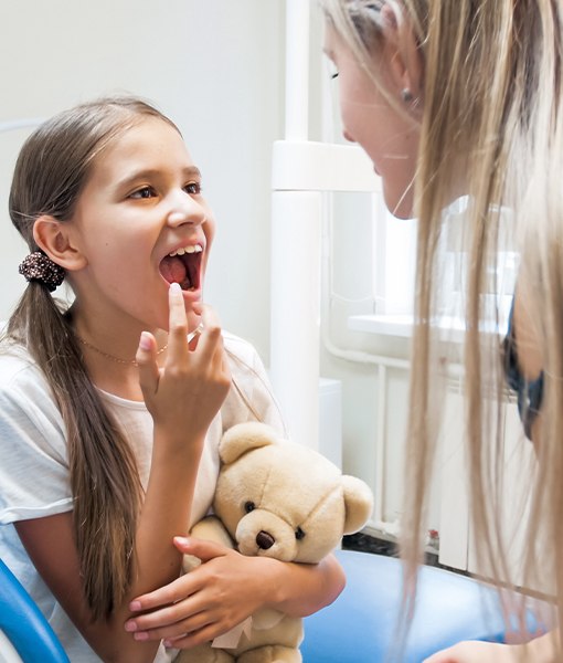 Child pointing to smile after pulp therapy