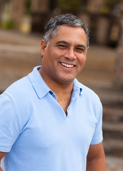 Man smiling after receiving root canal therapy