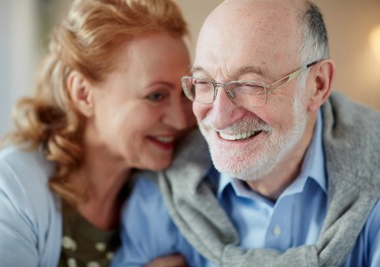 Man and woman with healthy smiles after periodontal therapy