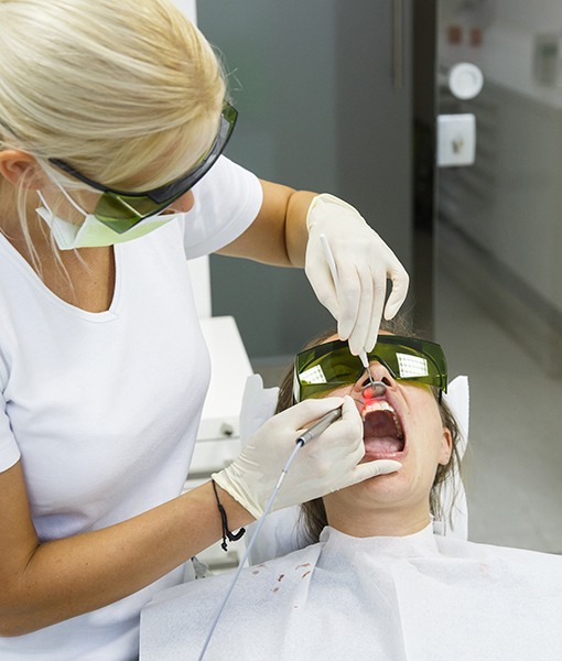 Patient receiving soft tissue laser dentistry treatment