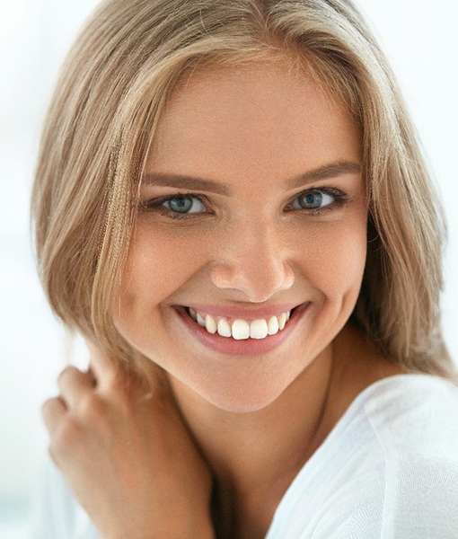 young woman smiling after teeth whitening Edmonton