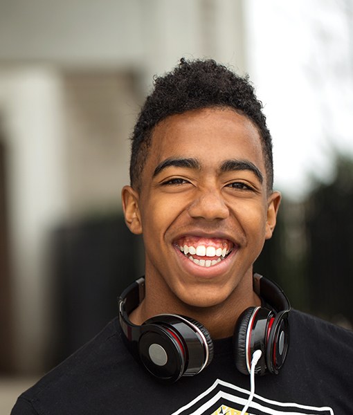 Young man with healthy smile after wisdom tooth extraction