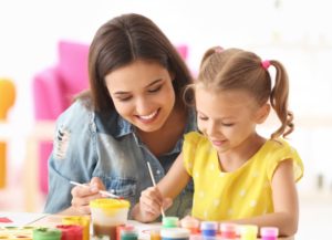 young girl in school coloring a picture