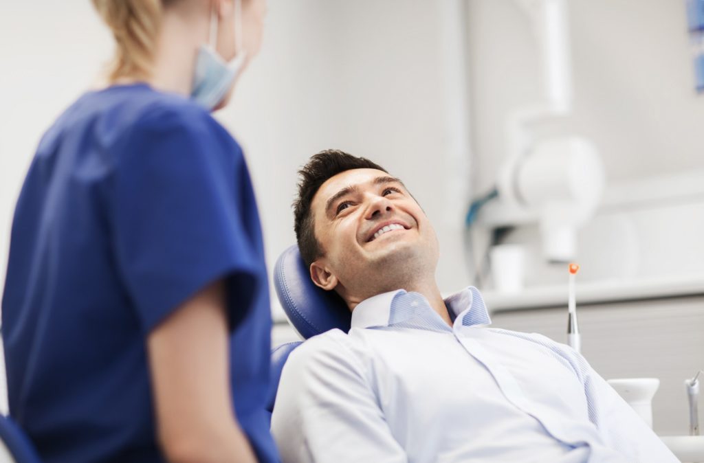 Man smiling at dentist during dental checkup