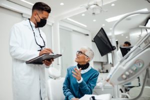 a patient discussing dental implants with her dentist in Edmonton